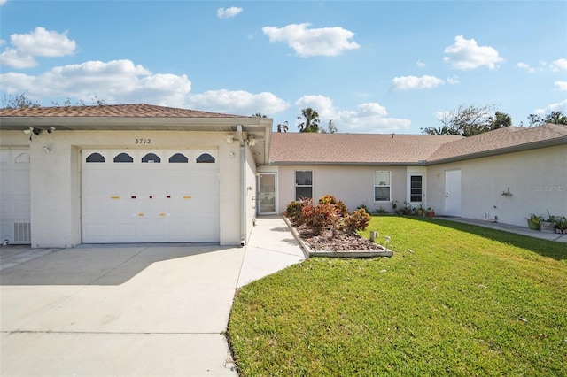 view of front of home with a garage and a front lawn