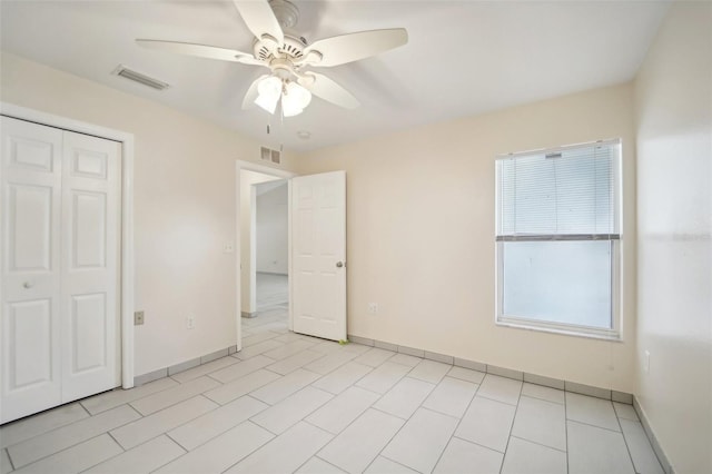 unfurnished bedroom featuring a closet and ceiling fan