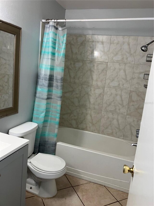 full bathroom with tile patterned floors, vanity, toilet, and shower / bath combo with shower curtain