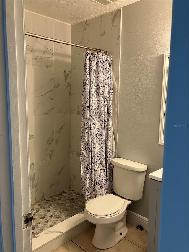 bathroom featuring tile patterned floors, a textured ceiling, toilet, vanity, and a shower with shower curtain