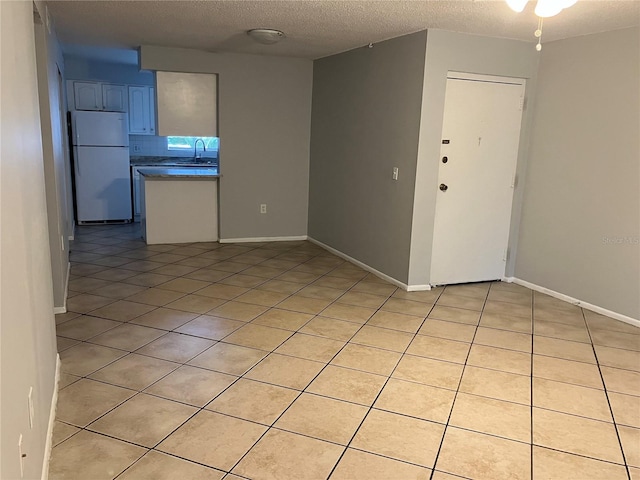 interior space featuring a textured ceiling and sink