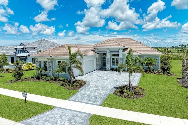 view of front of property featuring a garage and a front yard