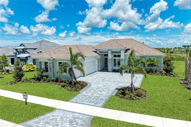 view of front of property featuring a garage and a front yard