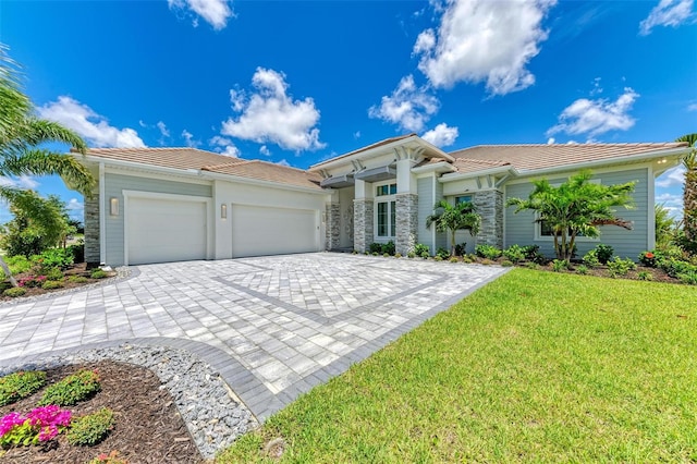 view of front facade with a front yard and a garage