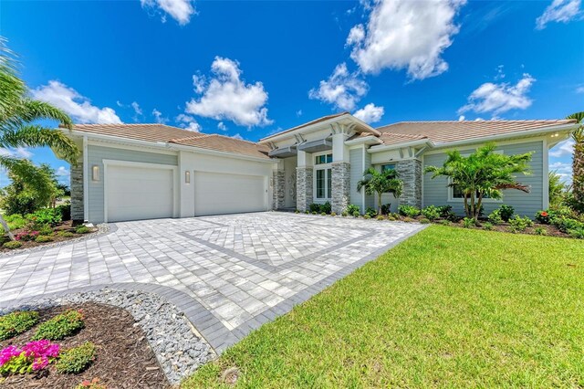 view of front facade with a front yard and a garage