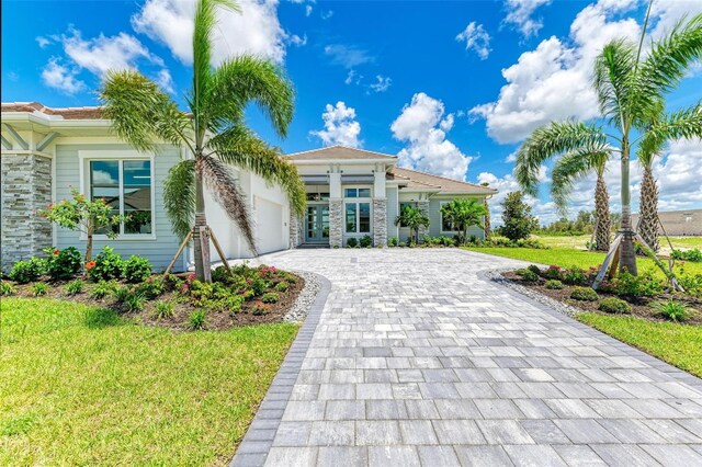 mediterranean / spanish-style house with a front yard