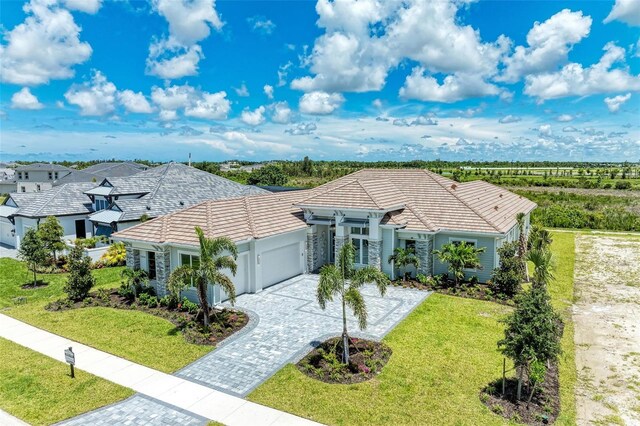 ranch-style home with a garage and a front yard