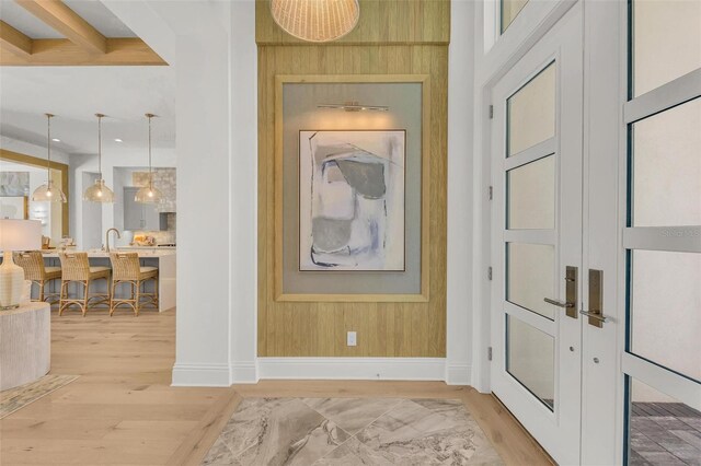 interior space featuring sink, hardwood / wood-style floors, and wooden walls