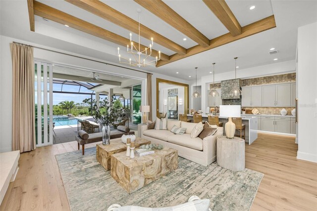 living room featuring beam ceiling and light hardwood / wood-style flooring