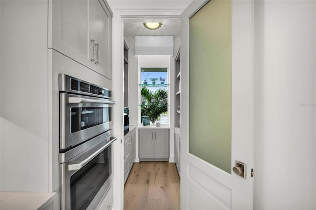 kitchen with light wood-type flooring and double oven