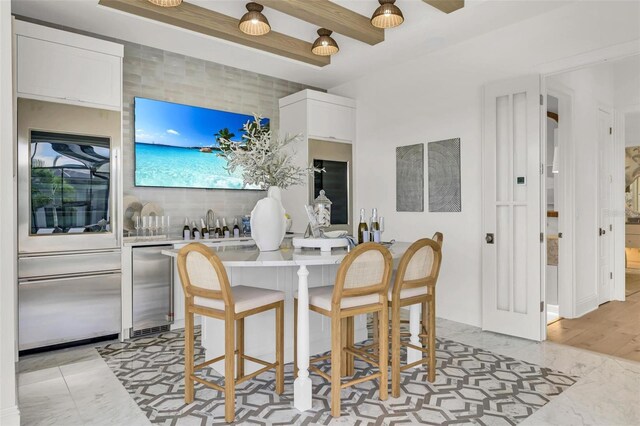 dining space with beam ceiling