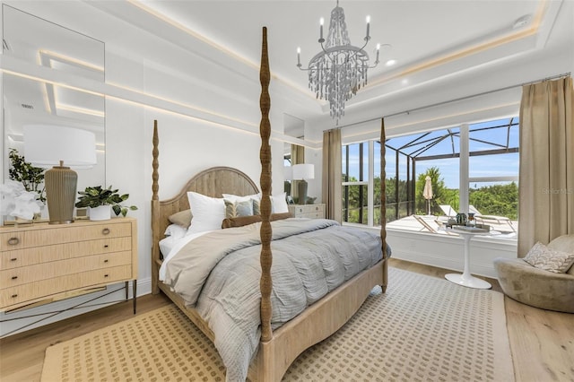 bedroom featuring hardwood / wood-style floors and a tray ceiling