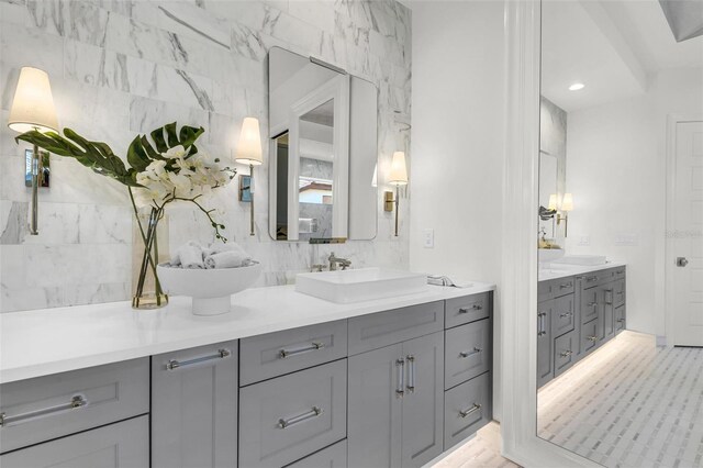 bathroom with tile walls and vanity