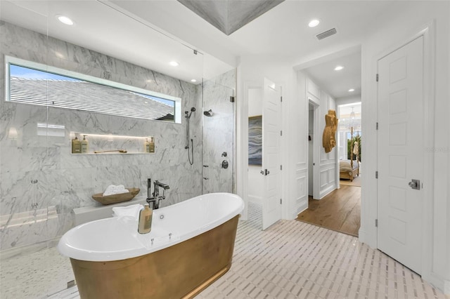 bathroom with tile walls, tile patterned floors, and plus walk in shower