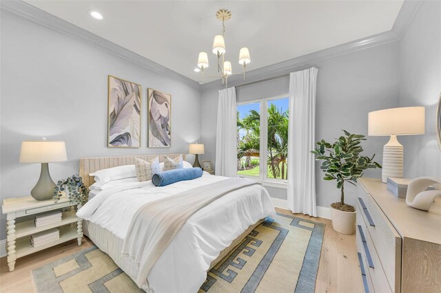 bedroom featuring a notable chandelier, light wood-type flooring, and crown molding