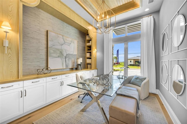 dining space featuring wooden ceiling, a tray ceiling, and light hardwood / wood-style flooring