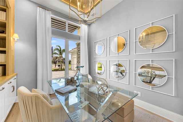 sitting room with an inviting chandelier and light hardwood / wood-style floors