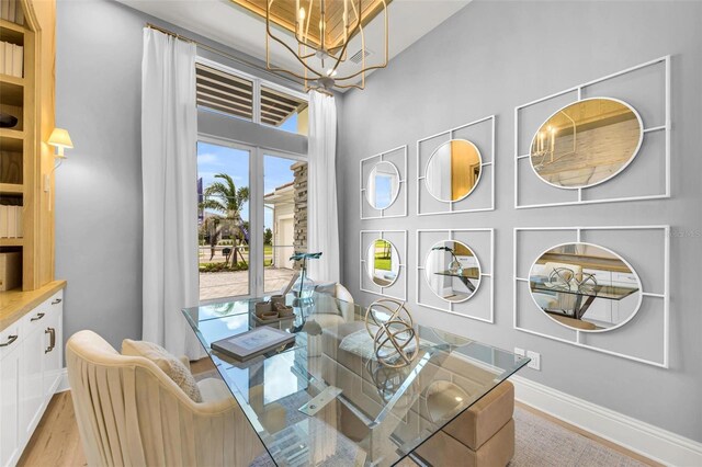 sitting room with an inviting chandelier and light hardwood / wood-style floors