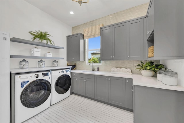 laundry area with cabinets, sink, and independent washer and dryer