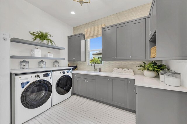 laundry area with cabinets, sink, and independent washer and dryer