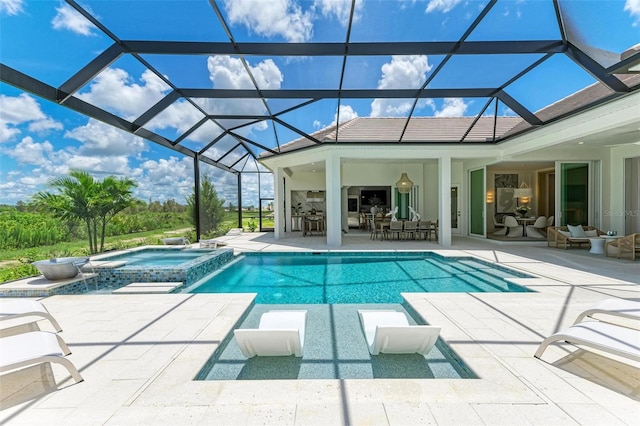 view of pool with an in ground hot tub, a lanai, a patio area, and an outdoor hangout area