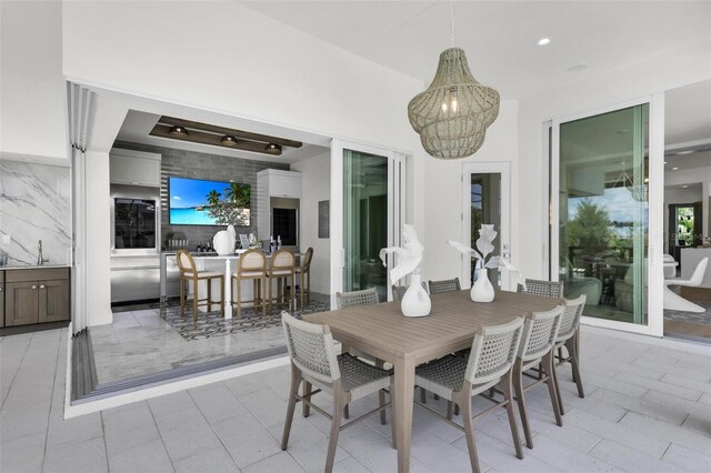 tiled dining space featuring a notable chandelier