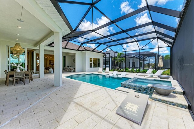 view of pool with glass enclosure, an in ground hot tub, and a patio