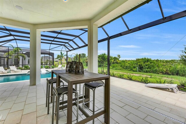 view of patio / terrace featuring a lanai