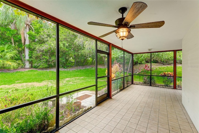 unfurnished sunroom featuring ceiling fan