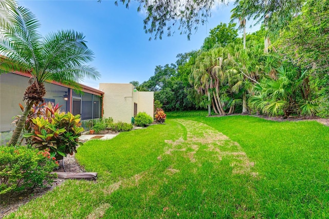 view of yard featuring a sunroom