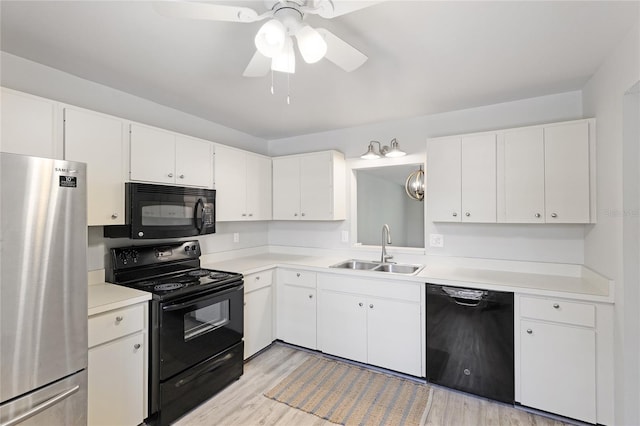 kitchen with white cabinetry, sink, light hardwood / wood-style flooring, and black appliances