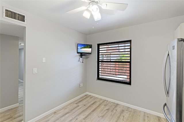 spare room featuring ceiling fan and light hardwood / wood-style floors