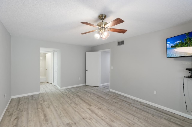 interior space featuring ceiling fan, a textured ceiling, and light hardwood / wood-style flooring