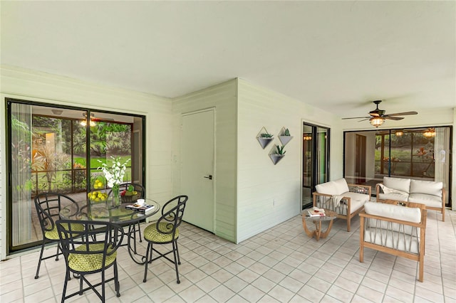 tiled dining space featuring ceiling fan