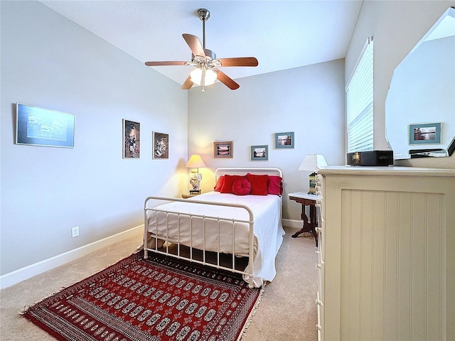 carpeted bedroom featuring baseboards and a ceiling fan