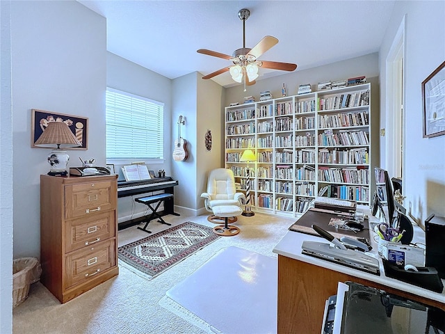 office space featuring carpet floors, baseboards, and a ceiling fan