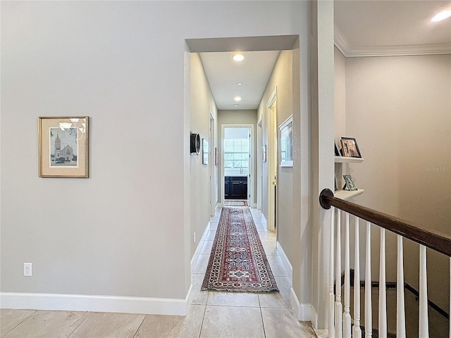 hallway with ornamental molding, light tile patterned flooring, recessed lighting, and baseboards