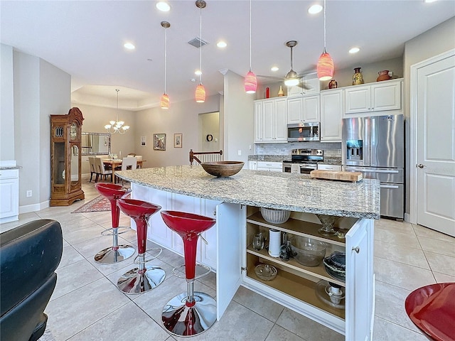 kitchen featuring stainless steel appliances, visible vents, white cabinetry, open shelves, and tasteful backsplash