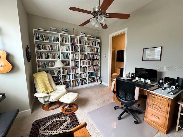 office with light carpet, ceiling fan, and baseboards