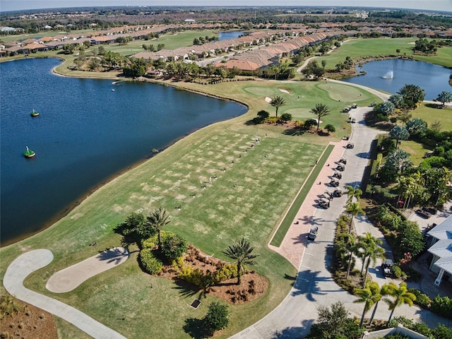 birds eye view of property with view of golf course and a water view