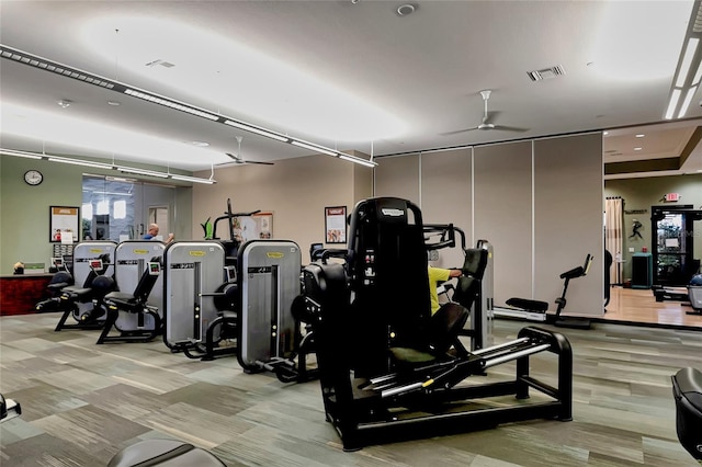 gym with ceiling fan and visible vents