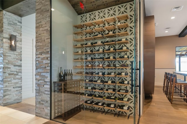 wine room with recessed lighting, visible vents, and wood finished floors