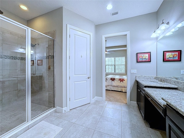 bathroom with visible vents, connected bathroom, a shower stall, vanity, and tile patterned flooring