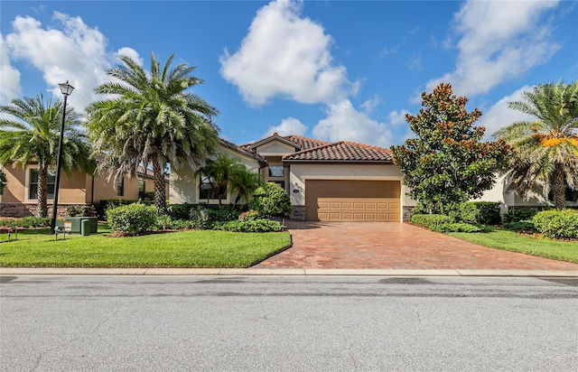 mediterranean / spanish house with a front yard and a garage