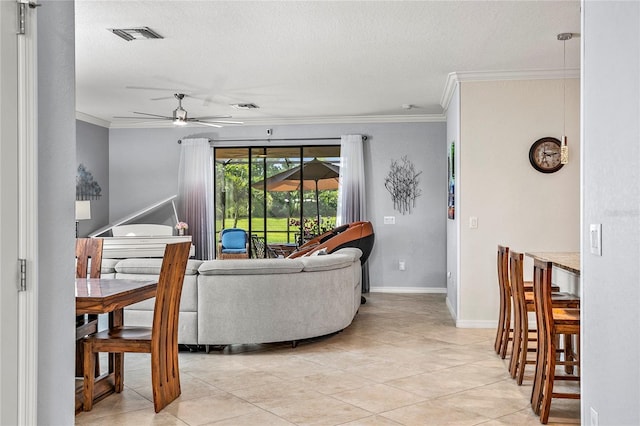 living room with light tile patterned floors, ceiling fan, and ornamental molding