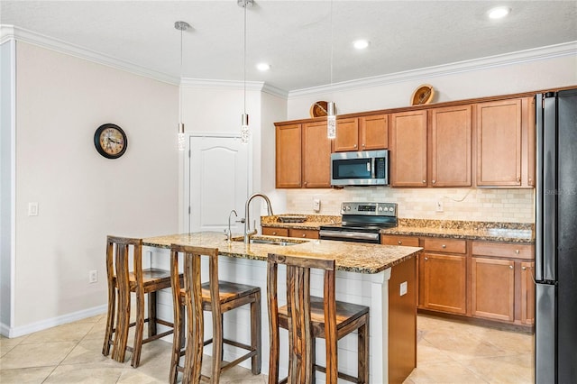 kitchen with sink, hanging light fixtures, a breakfast bar, a center island with sink, and appliances with stainless steel finishes