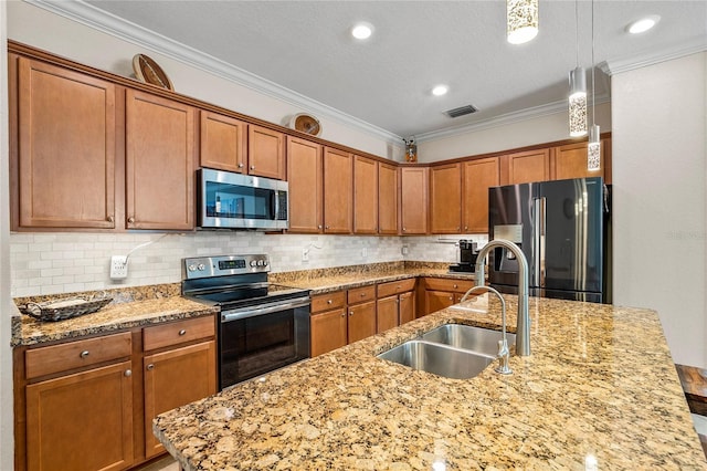 kitchen featuring decorative backsplash, light stone countertops, stainless steel appliances, sink, and pendant lighting