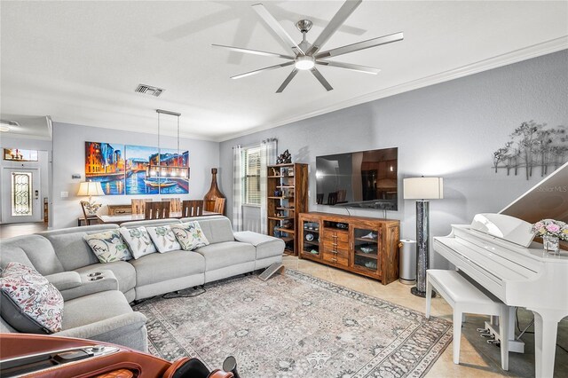 living room with light tile patterned floors, ceiling fan, and ornamental molding