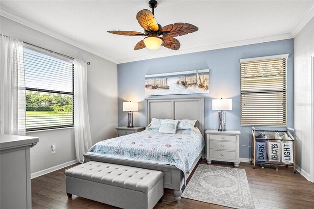 bedroom featuring ornamental molding, ceiling fan, and dark wood-type flooring