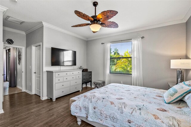 bedroom with dark hardwood / wood-style flooring, ceiling fan, and crown molding